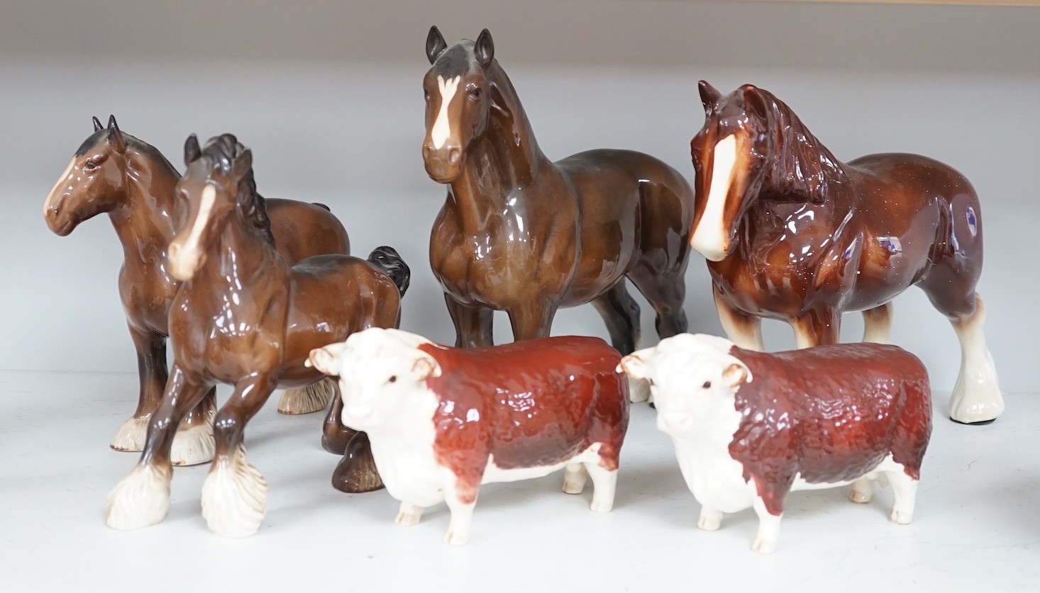 A group of four various Beswick Shire horses and two models of champion bulls, largest shire 27 cms high.